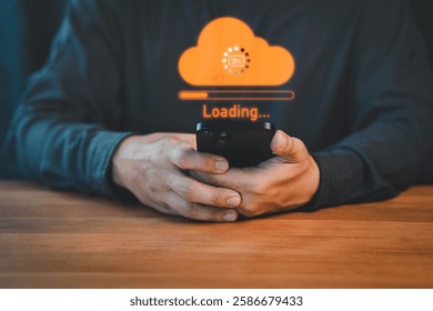 Person holding a smartphone with a glowing orange cloud upload icon and loading progress bar, representing cloud computing, data transfer, internet of things, and digital technology.