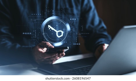 Person holding smartphone near laptop with digital key hologram on dark background, representing cybersecurity and password protection