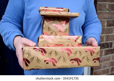 Person holding stack of parcels