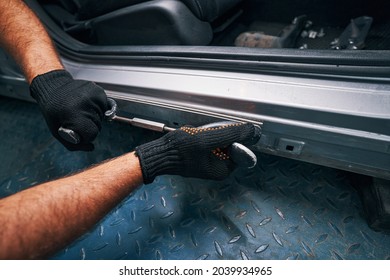 Person Holding Straightening Tool Pressed To Car Side Door Frame