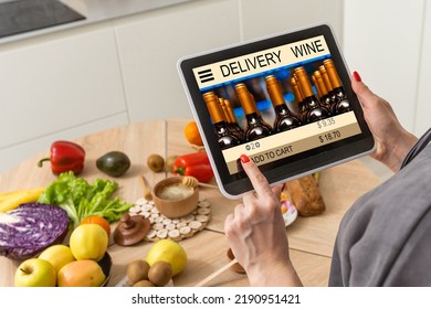 Person Holding Tablet And Buying Wine Online.