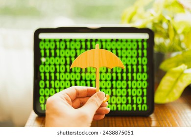 Person holding umbrella sign with background with green information on screen It is a concept about Digital data protection Preventing digital theft