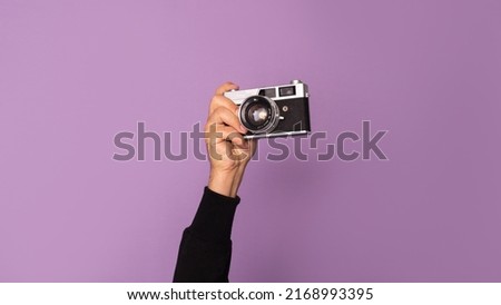 Person holding a vintage camera