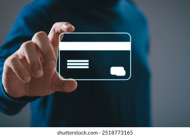 Person holding a virtual credit card with holographic display, representing futuristic payment technology and digital finance innovation. - Powered by Shutterstock