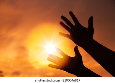 Person human hands open palm up worship or pray for god. background is sunrise. Concept for Christian, Christianity, Catholic religion, divine, heavenly, celestial or god. - Shutterstock ID 2190046819
