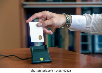 Person Inserting Smart Card With Digital Certificate In A Smart Card Reader