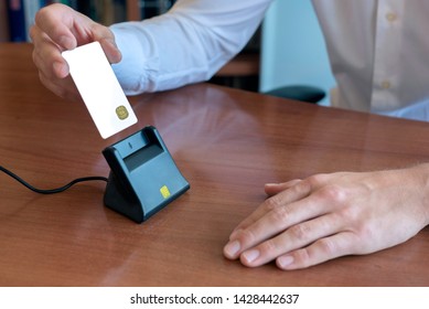 Person Inserting Smart Card With Digital Certificate In A Smart Card Reader