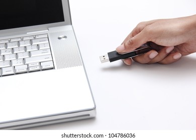 Person Inserting A Usb Thumb Drive Into A Laptop