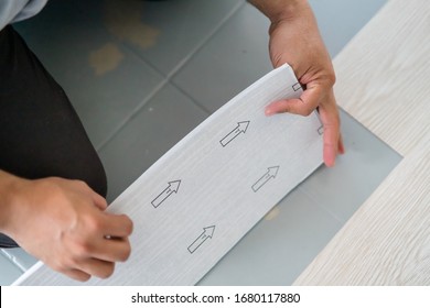 A Person Installing New Vinyl Tile Floor, A DIY Home Project.