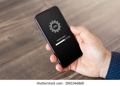 Person Installing Software Updates On Mobile Phone