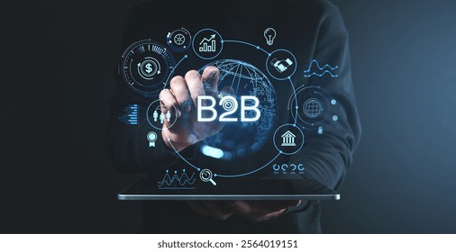 A person interacting with a digital interface displaying B2B icons, data charts, and global network visuals on a dark background. Business concept