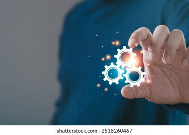 A person interacting with glowing gears, symbolizing innovation and technology in a modern workspace.