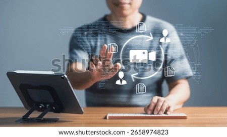 A person interacting with a virtual interface showing a global network with icons for video production, document sharing, and user collaboration in a circular workflow