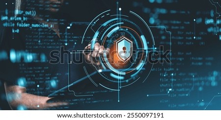 A person interacts with a cybersecurity interface featuring a shield icon and coding elements on a dark background, representing data protection