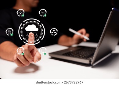 A person interacts with digital cloud technology, showcasing a laptop and interface icons, emphasizing connectivity and innovation in a modern workspace.