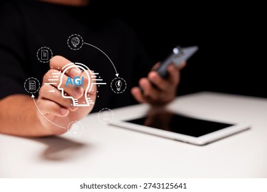 A person interacts with a digital interface displaying AGI concepts, holding a marker and smartphone near a tablet on a white desk.