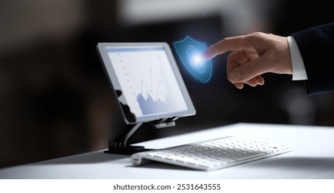 A person interacts with a digital tablet, using a stylus to engage with a virtual shield icon. Represents cybersecurity, data protection, and secure technology for modern devices