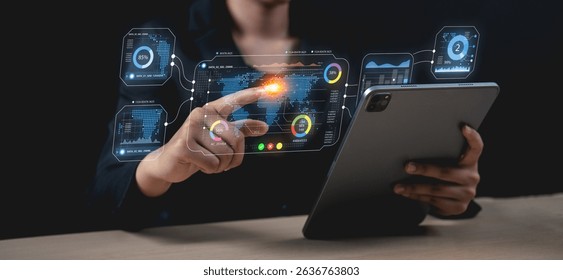 A person interacts with a futuristic digital interface using a tablet, showcasing advanced technology and data visualization.