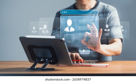 A person interacts with a virtual interface displaying multiple user profiles, video player controls, and data graphs, suggesting online content management