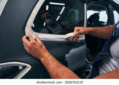 Person Isolating Car Windows With Duct Tape