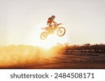 Person, jump and motorcyclist with sunset for trick, stunt or ramp on mockup or outdoor dirt track. Expert rider on motorbike in the air with lift off for extreme sports or rally challenge in nature