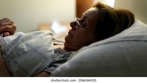 Person Laying Down In Bed Looking At Smartphone, Older Woman In Bed At Night Using Phone