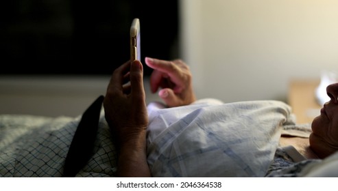 Person Laying Down In Bed Looking At Smartphone, Older Woman In Bed At Night Using Phone