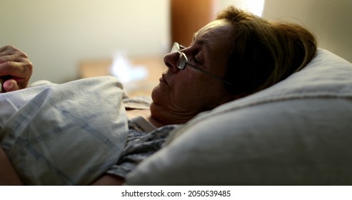 Person Laying Down In Bed Looking At Smartphone, Older Woman In Bed At Night Using Phone