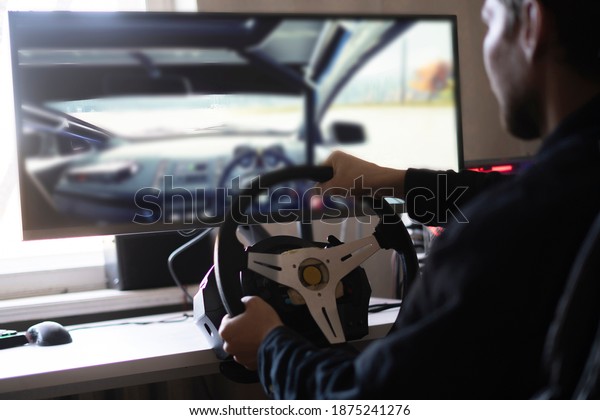 person learns how to drive the car using an\
auto computer simulator