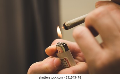 Person lighting a joint, spliff, or cigarette
