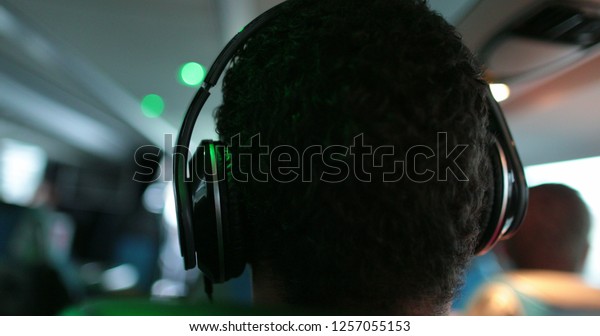 Person listening to music with headphones while
traveling by bus