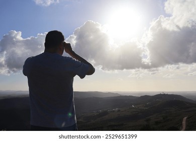 person looking into distance, contemplative, thoughtful, rear view, horizon, solitude, reflection, introspection, peaceful, landscape, outdoors, nature, distant view, calm, sunset, scenery, serene, ad - Powered by Shutterstock