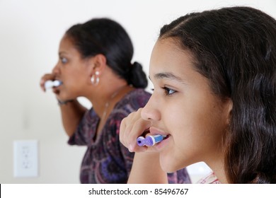 Person Looking Into A Mirror Brushing Their Teeth