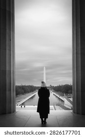A person looking out at the Reflection pool in Washington DC