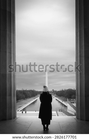 A person looking out at the Reflection pool in Washington DC
