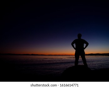 Person Looking Over Ocean At Sunset