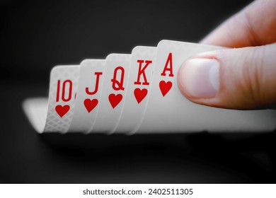 A person looking at a Royal flush An ace-high straight flush, the best possible hand in many variants of poker. - Powered by Shutterstock