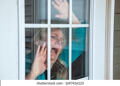 Person Looks Out Their Front Door With An Anxious Expression Wanting Freedom