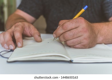 a person makes an entry in a notebook for doing business