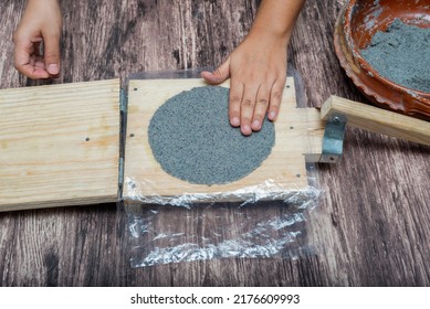 Person Making Corn Tortillas At Home With A Hand Tortilla Maker.