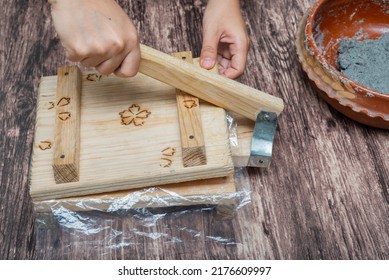 Person Making Corn Tortillas At Home With A Hand Tortilla Maker.