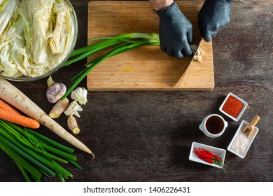 Person Making Kimchi Wearing Black Rubber Gloves For Protection