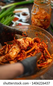 Person Making Kimchi Wearing Black Rubber Gloves For Protection