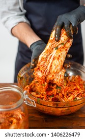 Person Making Kimchi Wearing Black Rubber Gloves For Protection