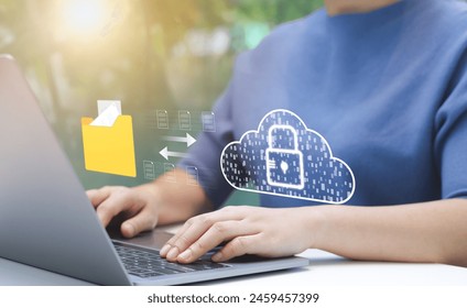 Person Managing Secure Cloud Data Transfer. An individual uses laptop to manage secure data transfer to cloud, virtual lock, representing robust cybersecurity measures. File storage, Manage folders,