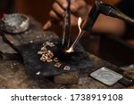 A person is melting silver to make jewellery.