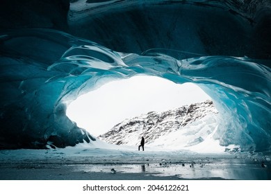 Person in the middle of ice cave with aurora, during stunnig winter evening,Iceland, texture of ice - Powered by Shutterstock