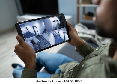 Person Monitoring Cameras Live View Of Home On The Digital Tablet
