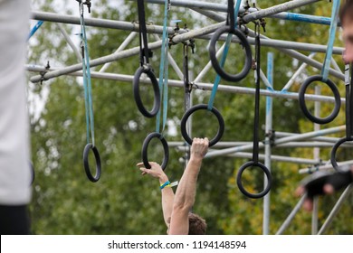 A Person On Hanging Rings During An Adventure Obstacle Course Race