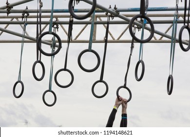 A person on hanging rings during an adventure obstacle course race